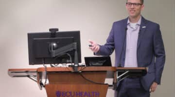 ECU Health CFO Andy Zukowski speaks to ECU Health team members during a presentation.