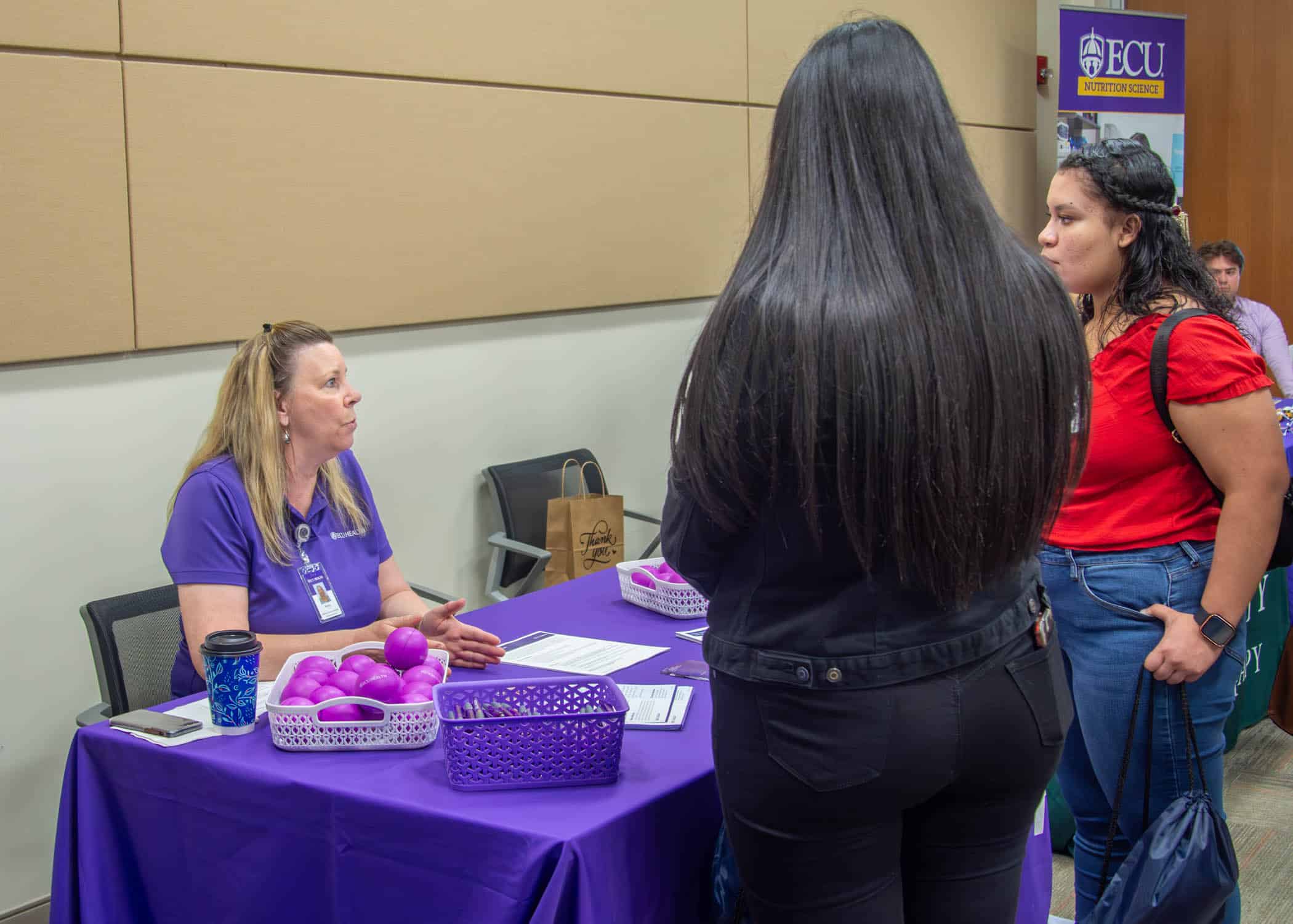 An ECU Health team member talks to local students about careers in health care.