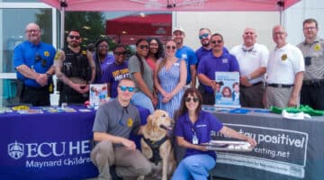 A group of ECU Health team members, first responders and local partners gather together for a photo during a Hot Car Safety event in Greenville.