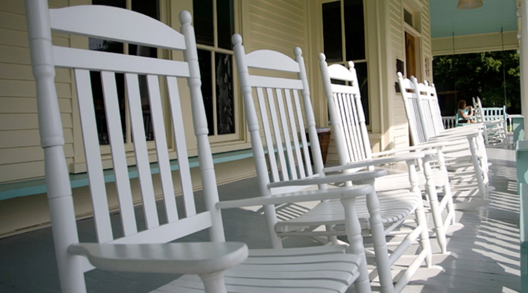 Rocking chairs sit on the front porch of a home in a rural eastern North Carolina town.