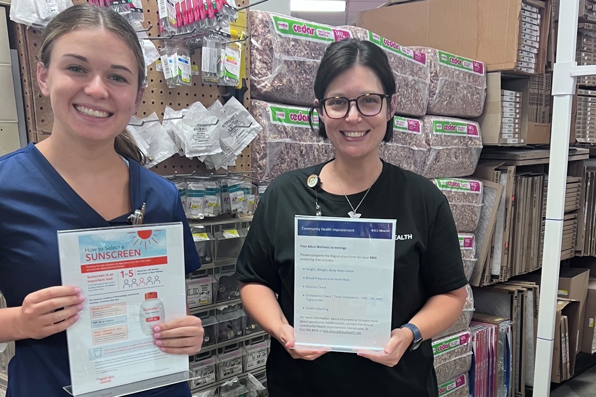 Two ECU Health team members pose for a photo inside of a hardware store in eastern North Carolina, where they shared information on skin cancer risks and safety tips.