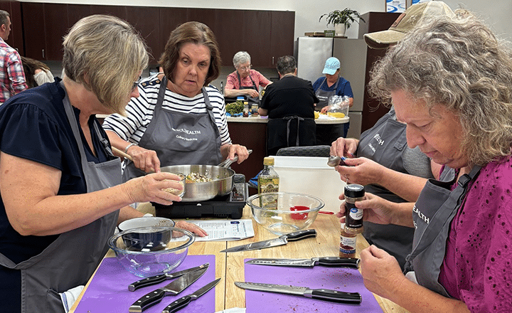 Community members participate in a healthy cooking class at ECU Health Wellness Center.