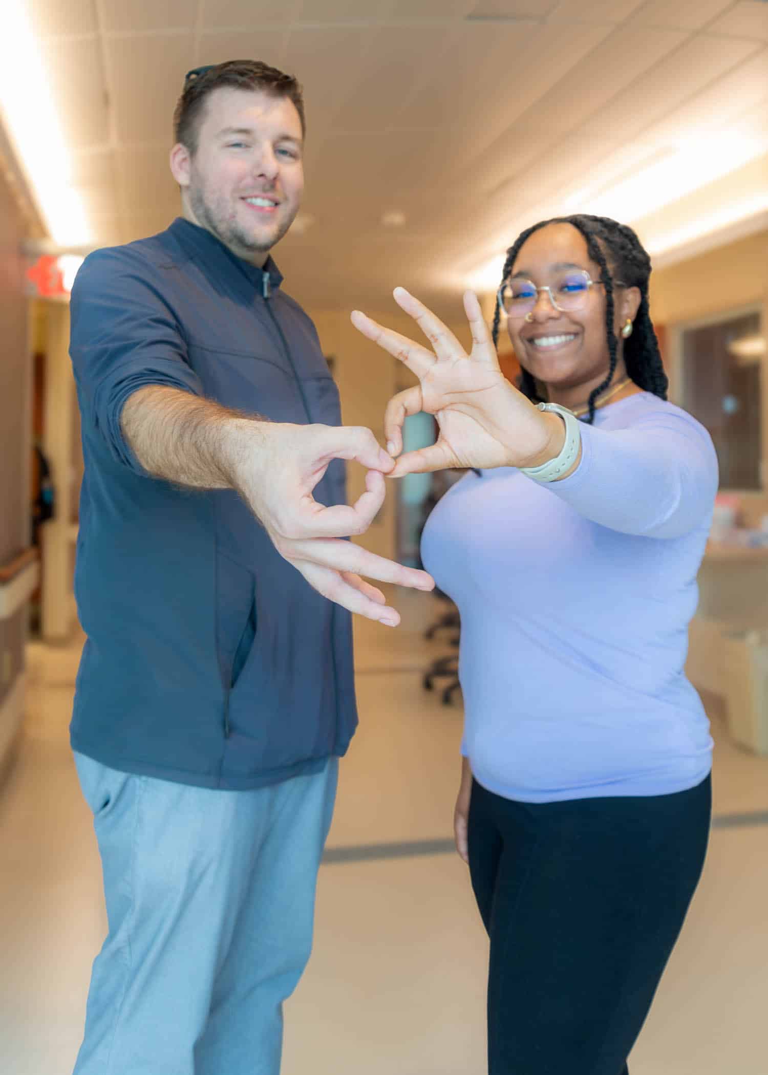 Two ECU Health interpreters sign interpreter in American Sign Language.