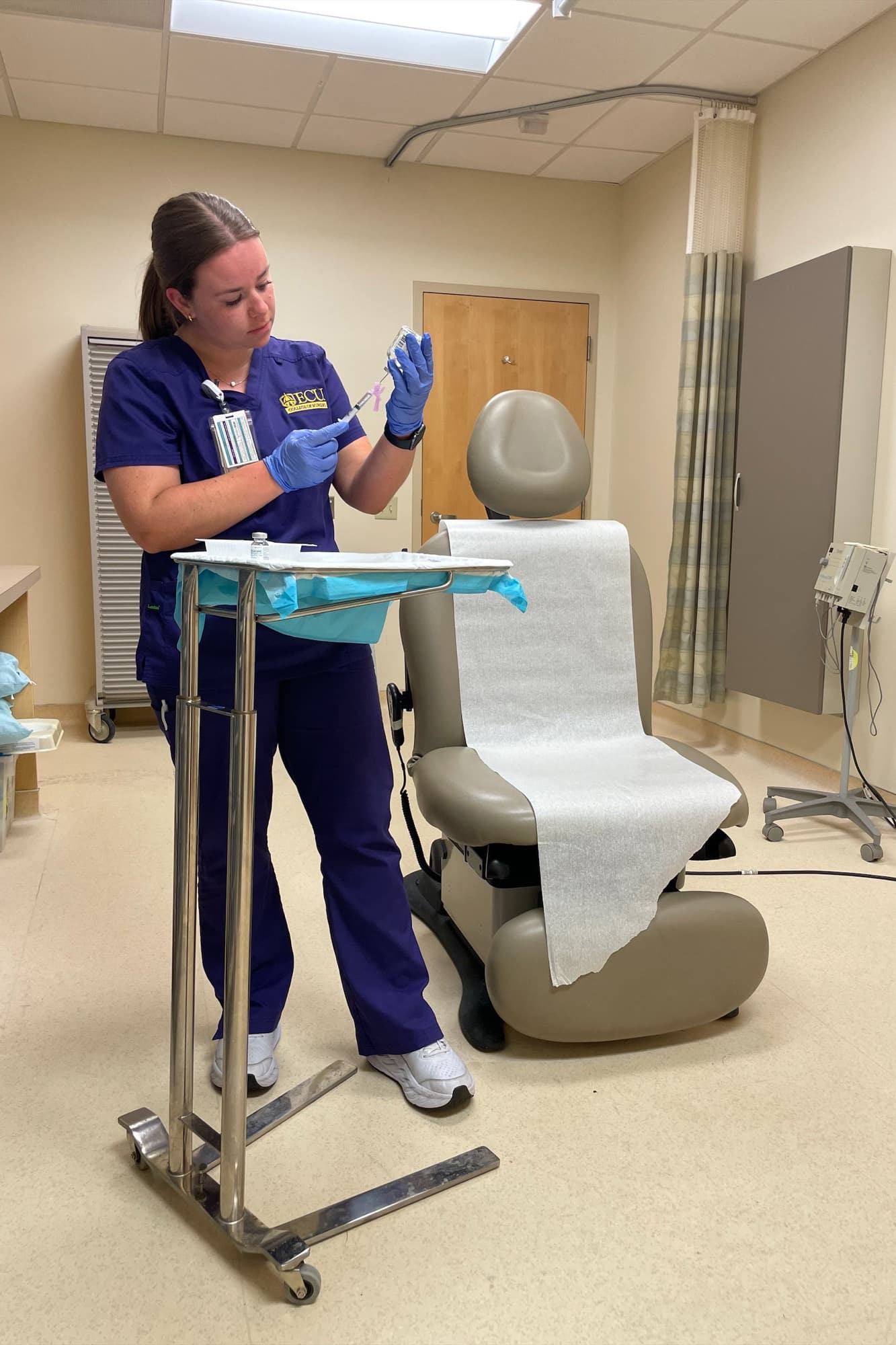 Emma Campbell, a College of Nursing student nurse extern, prepares the ambulatory clinic at ECU Health Medical Center for a patient.