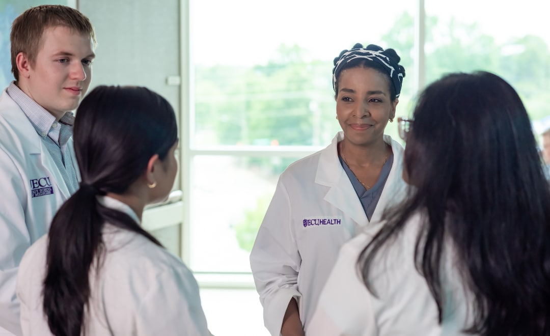 A team of physicians at East Carolina Heart Institute gathers to discuss patient care.