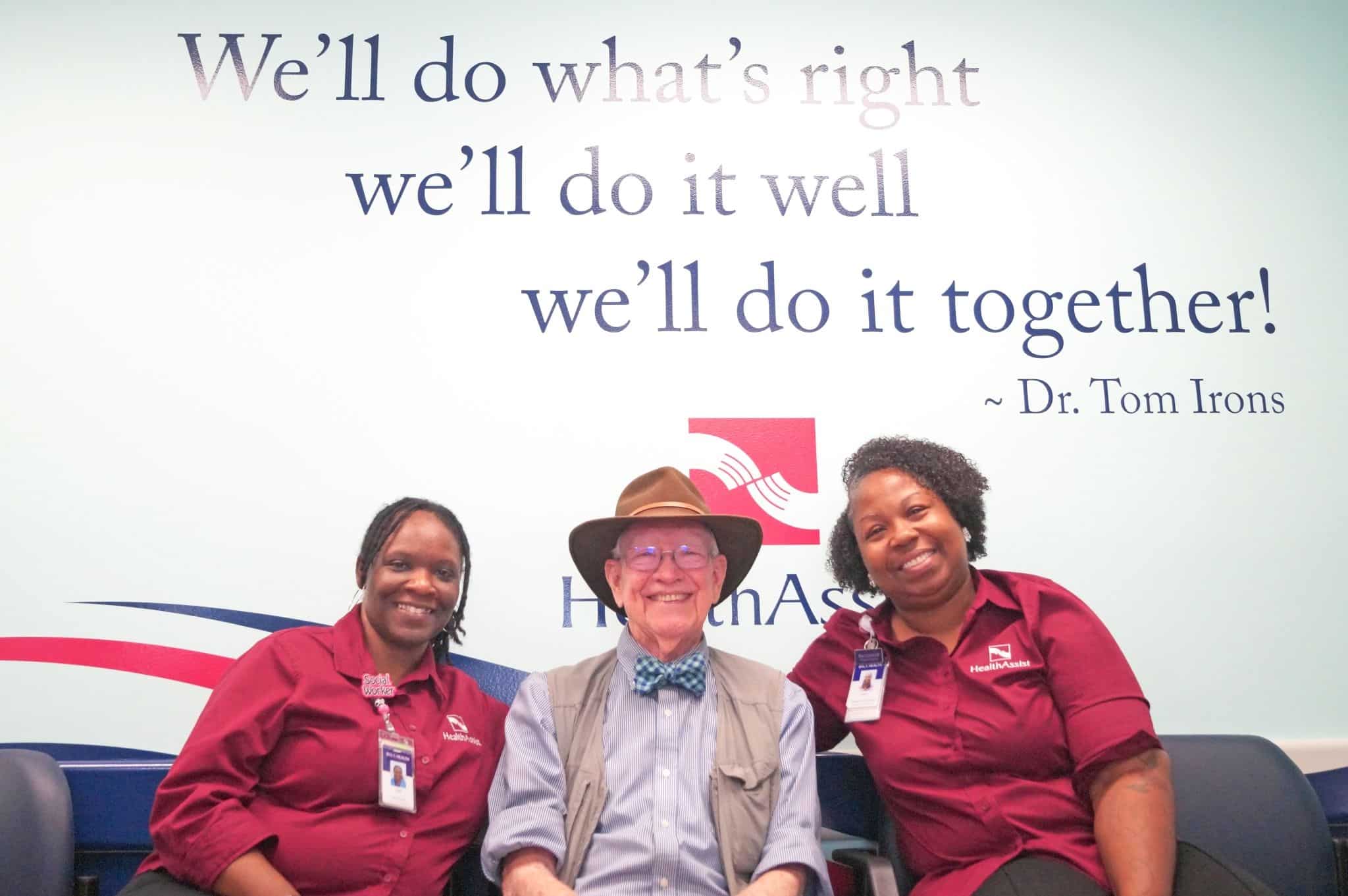 Members of the HealthAssist team sit with Dr. Tom Irons for a photo.