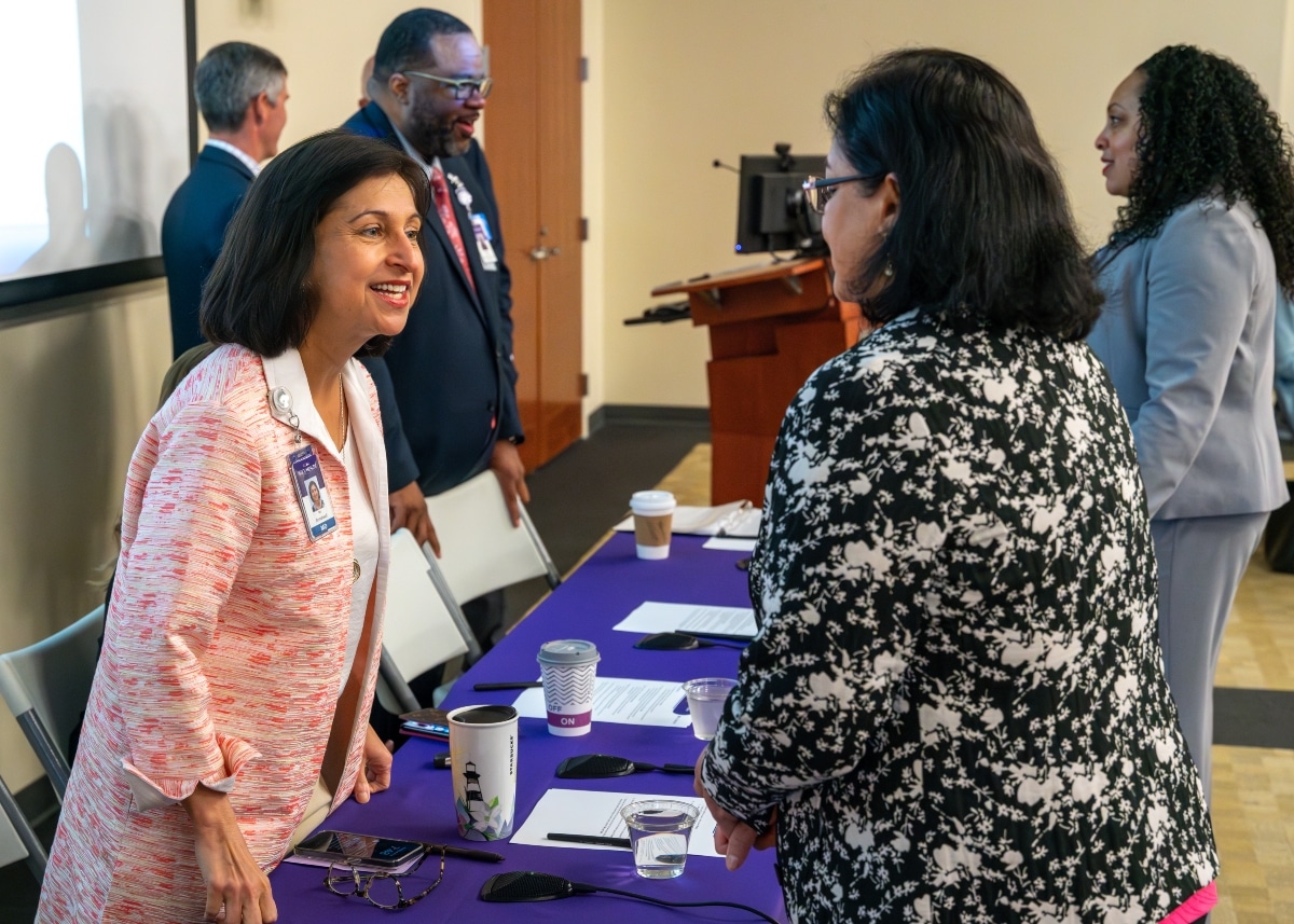 Dr. Niti Armistead, chief quality and clinical officer at ECU Health, speaks to an attendee during a C-Suite roundtable discussion.