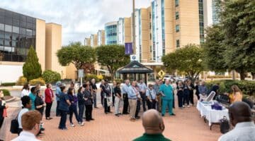 ECU Health team members gather together outside of ECU Health Medical Center to recognize Veterans Day.