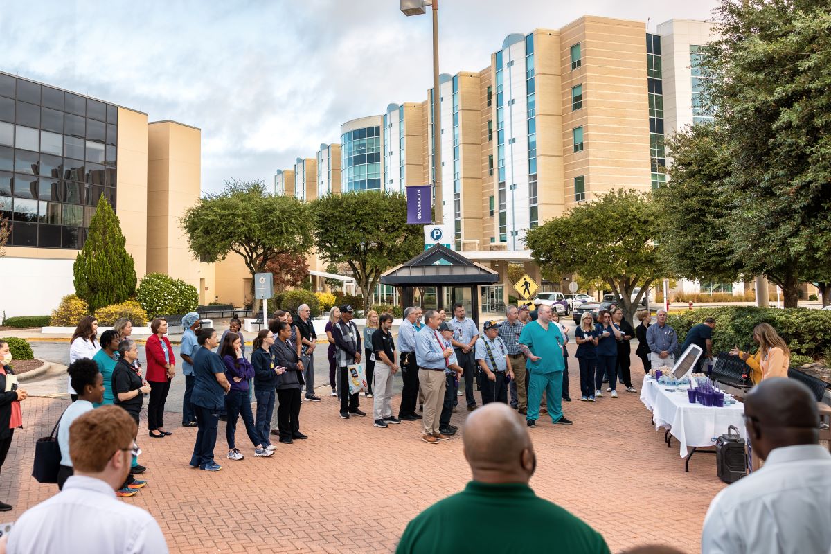 ECU Health team members gather together outside of ECU Health Medical Center to recognize Veterans Day.