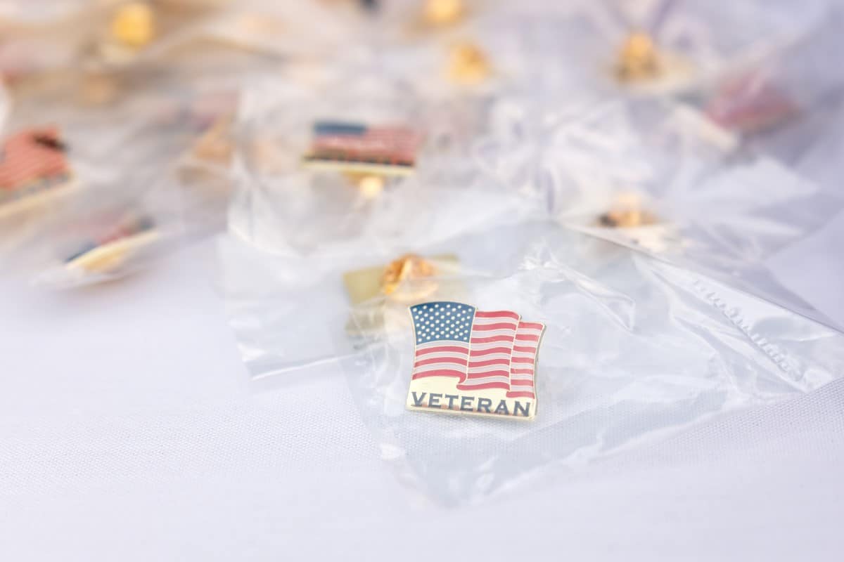 Veteran pins are shown on a table. Veterans were encouraged to take one home.