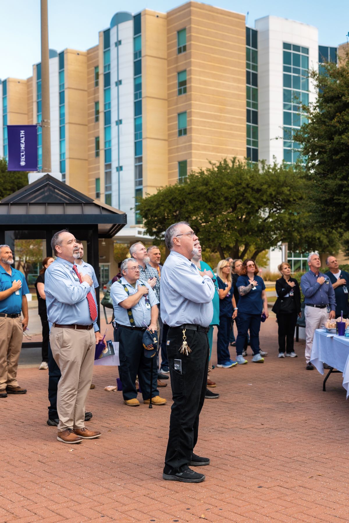 Wayne Waters, center, leads the group in the Pledge of Allegiance during the event.