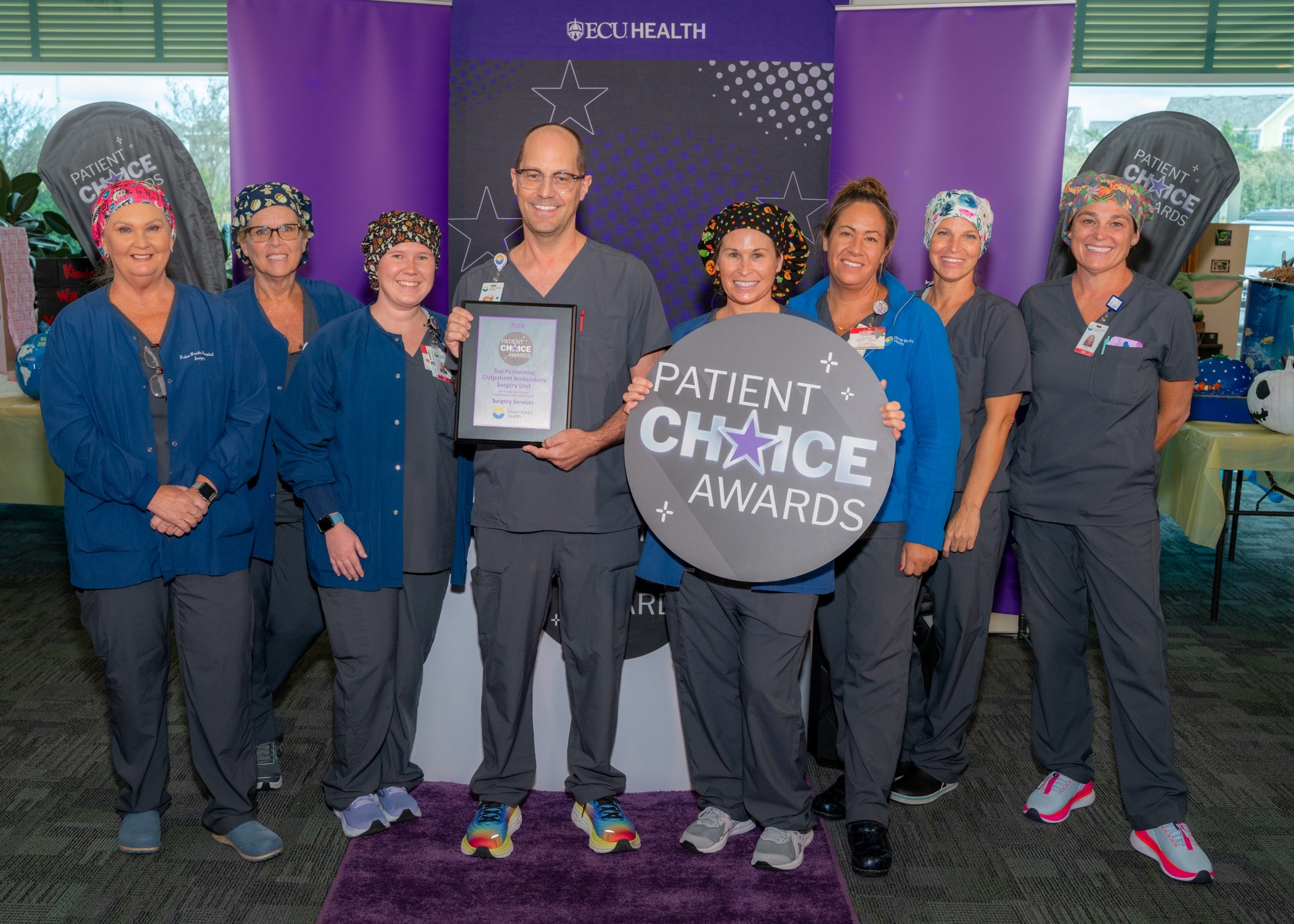 The team from Outer Banks Health Hospital takes a photo to celebrate their Patient Choice Award for Top Performing Outpatient Ambulatory Surgery Unit for Create a Caring Environment that Helps Heal.